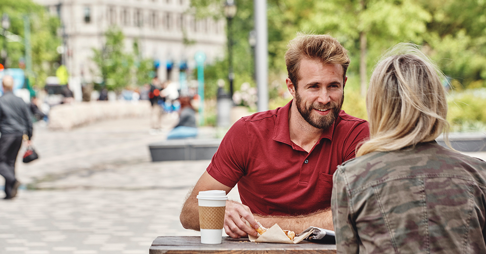 man in red polo on a date with a blonde girl