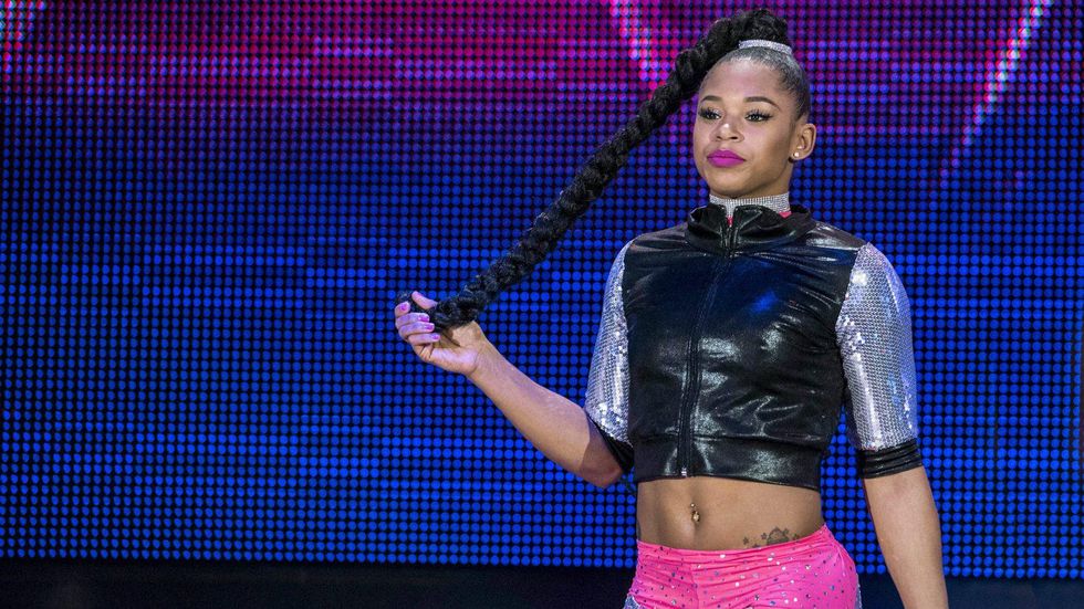 Bianca Belair holding her hair