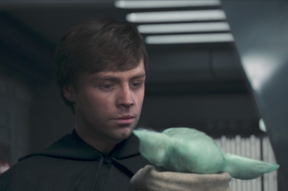 Luke Skywalker holding Grogu in The Mandalorian